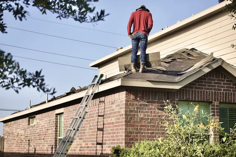 Professional roofer working on a residential roof in Pilot Mountain
